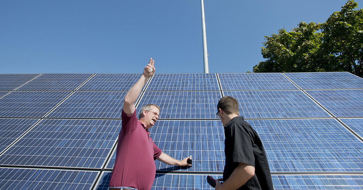 An instructor shows solar panels to a student at the RMTC.