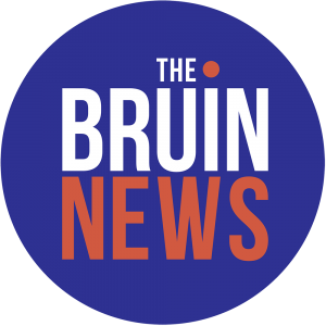 The Bruin News logo, which reads "The Bruin News" in white and orange type on a purple circle background.