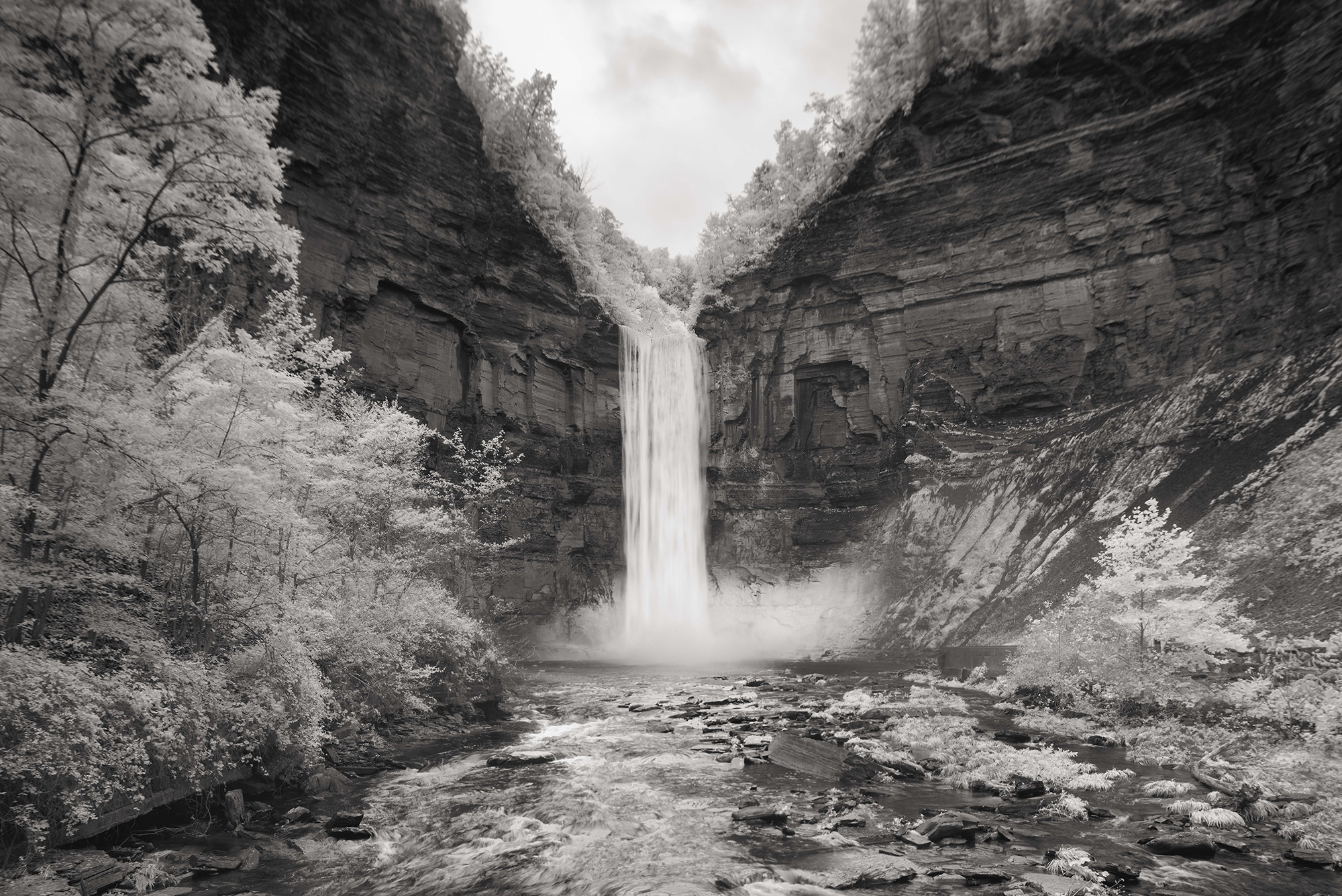 A black and white photo of a waterfall.